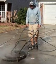 using a surface cleaner to Deep Clean a concrete driveway in Charlotte, NC.
