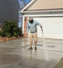 Pressure Rinsing a Driveway after Surface Cleaning in Charlotte, NC.